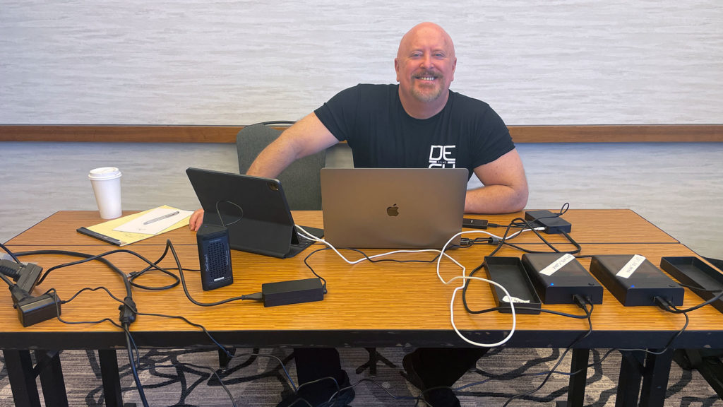 Big Brothers Big Sisters of America Conference 2022 smiling at desk Chris Rogers